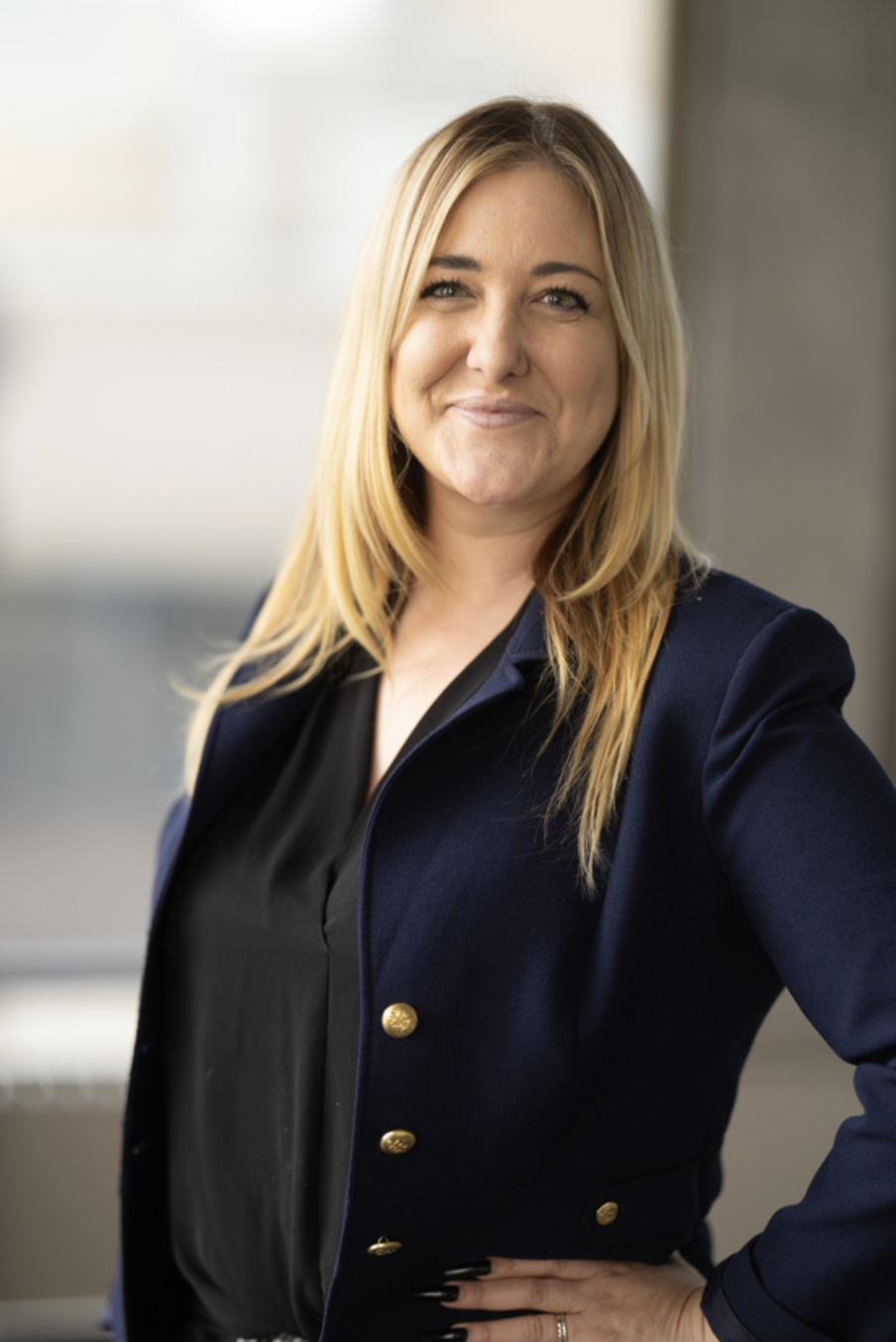 Blonde woman in blue blazer smiling