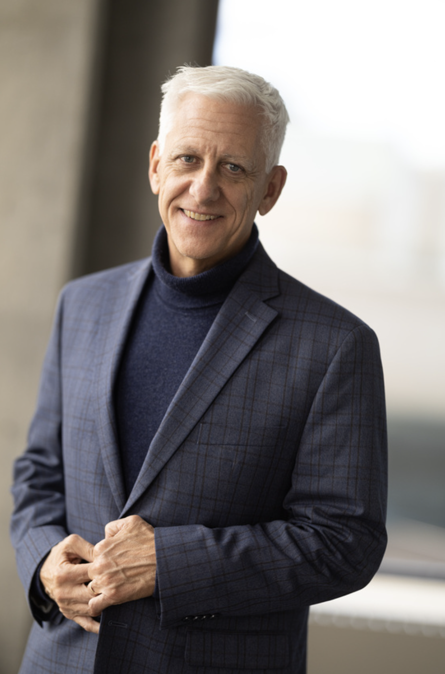 Man in blue turtleneck and blazer