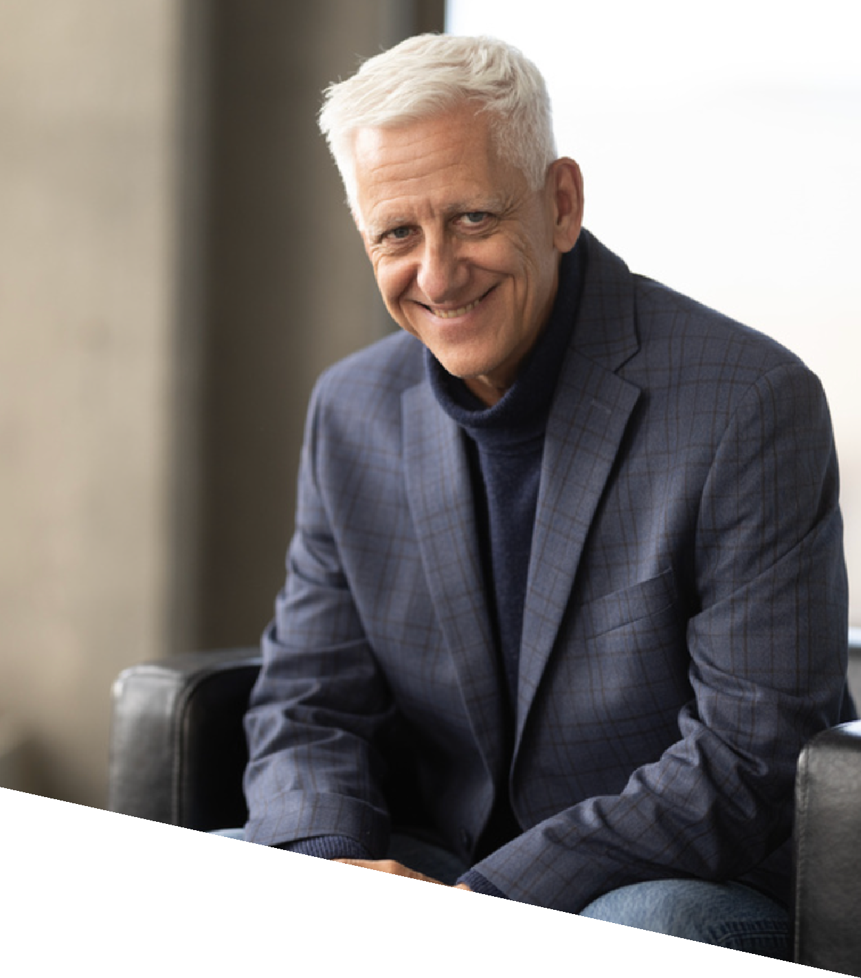 Smiling man in blue blazer and turtleneck